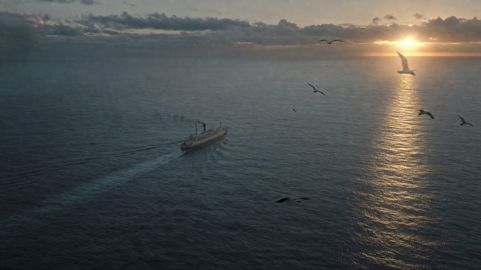 A ship crosses a calm sea toward the rising sun.